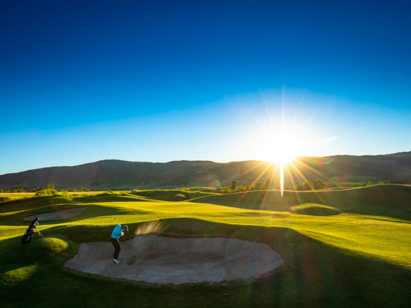 Golfer hitting out of a bunker